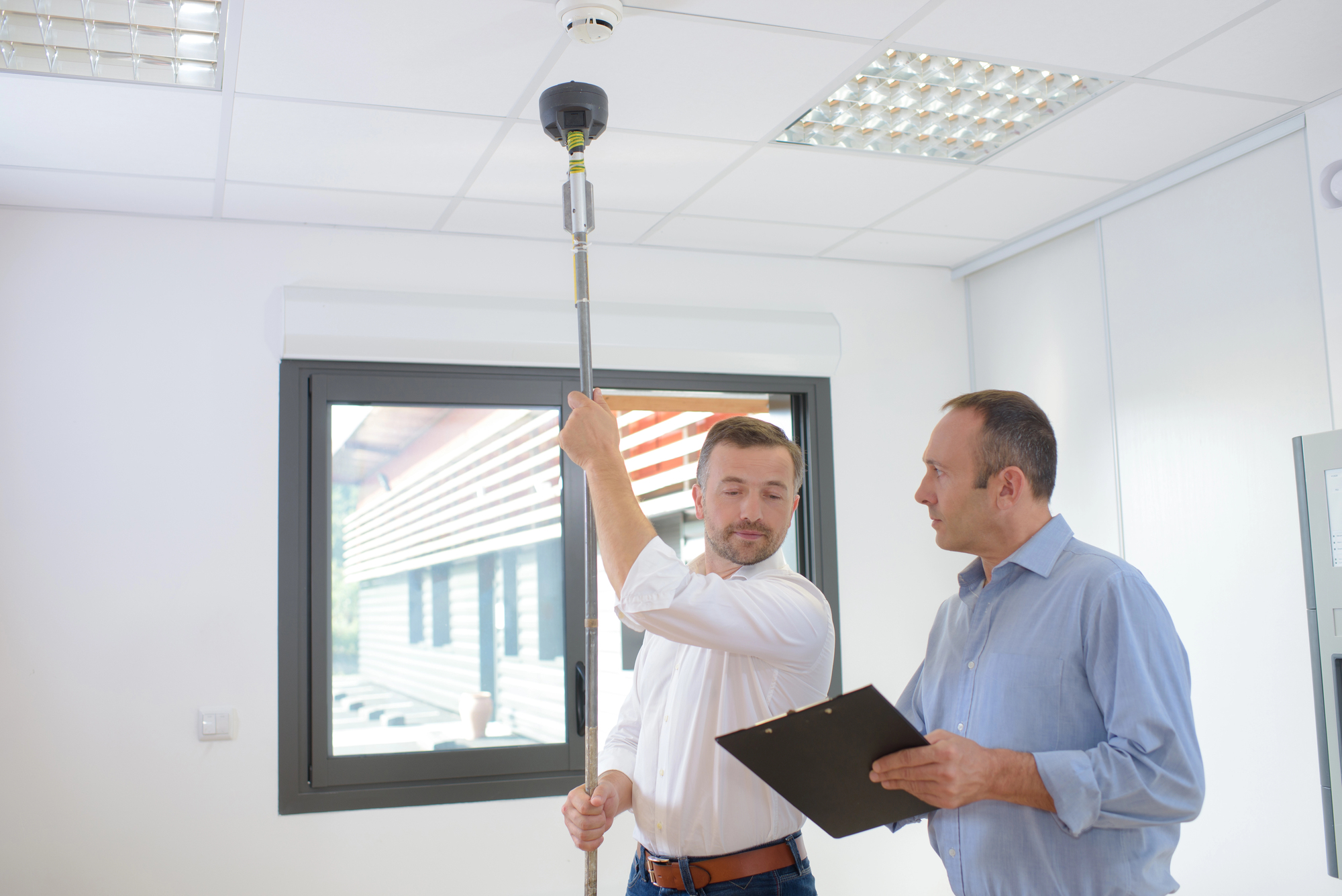 Fire alarm inspectors reviewing compliance documentation for an Ohio commercial property